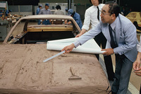 同じ現場で1分の1クレイモデルを製作中のモデラーに指示を出す桜井氏、という図。