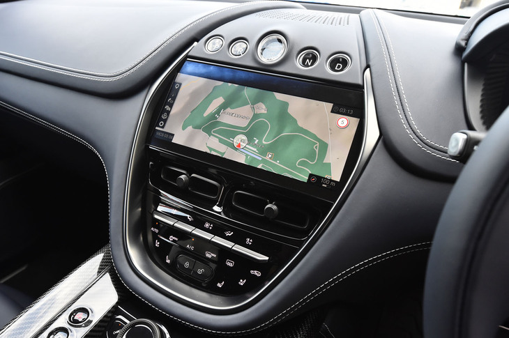 10.25インチのタッチ式ディスプレイの上部にエンジンスターターとシフトセレクタースイッチを配置。トリムのカラーや素材、加飾パネルなどの仕様はオーダーメイドプログラム「Q by Aston Martin」によってパーソナライズできる。