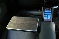 アームレストに備わる回転格納テーブル。身だしなみのチェックに便利なバニティーミラーが備わり、また出したままでも乗り降りできるようヒンジが工夫されている。