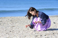 キャンドル作りに使う貝殻を探す生田さん。シーグラス(波にもまれて角の取れたガラス片)も探していたそうだが、今回は見つからなかった。