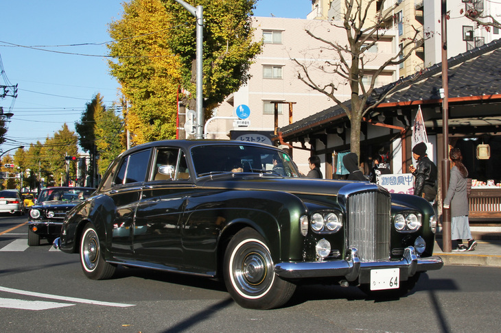 ロータリーに進入する1964年「ベントレーS3サルーン」。6.2リッターV8エンジンを積んだ「ロールス・ロイス・シルバークラウドIII」の双子車。