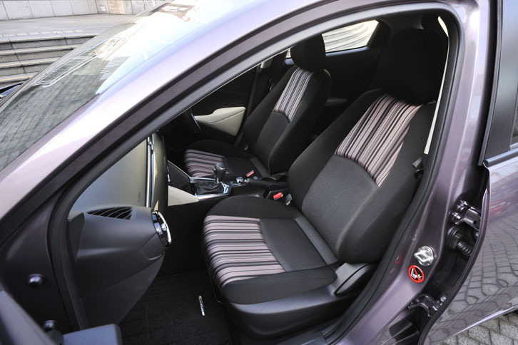 「デミオ アーバンスタイリッシュモード」（2015年4月23日発売）は、クルマにファッション性を求める、スタイリッシュな大人の女性をイメージしたモデル。ピンクストライプのシートが装着されていた。