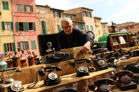 筆者が住むシエナの骨董（こっとう）市にて。古いダイヤル式電話機を陳列するアマチュアコレクター、ピエロさん。