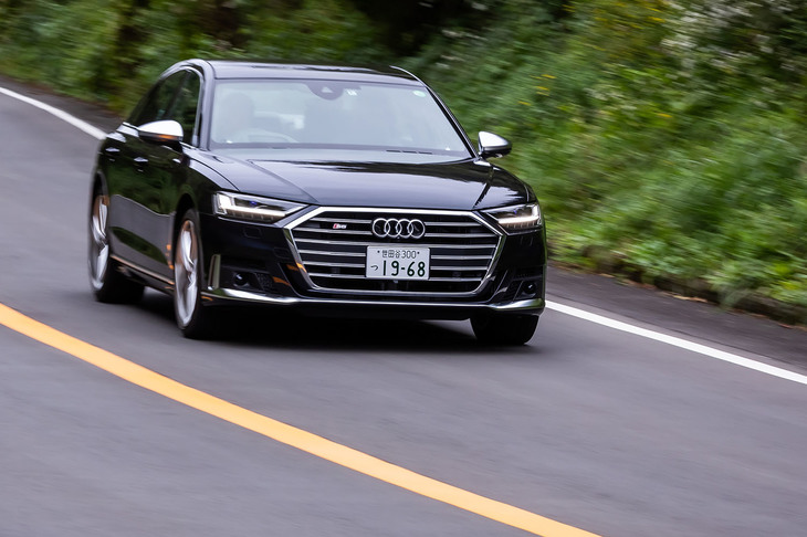 「プレディクティブアクティブサスペンション」を作動させた左コーナーでの走行シーン。室内では水平に近いレベルが維持されているが、外から眺めるとアウト側のサスペンションが伸びてロールが抑えられた様子が確認できる。