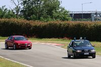 アレーゼのアルファ・ロメオ博物館にあるミニサーキットで。「そこの赤い『アルファ・ロメオ159』、止まりなさい！」と警告して、先まわりしたかのようなワンシーン。