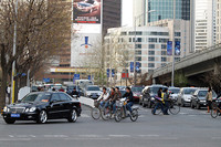 北京の町を走るメルセデス・ベンツと自転車。大都会ではよく見る風景だ。