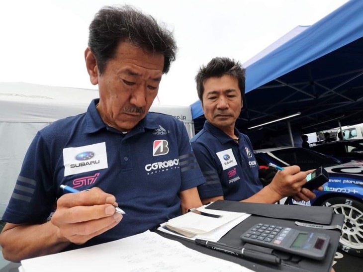 チーム全員での朝礼が終わったら、専有走行に向けての準備をしていきます。専有走行では87号／88号／89号車の3台ともがニュータイヤを入れて予選シミュレーションをしました。写真は、監督の佐野さん（左側）とメカニックの別所さんが内圧やセットの最終確認をしている様子です。この日は朝から天気が落ち着かず、雨が降ったりやんだりと、セッティングの判断をするのがとても難しいコンディションでした。