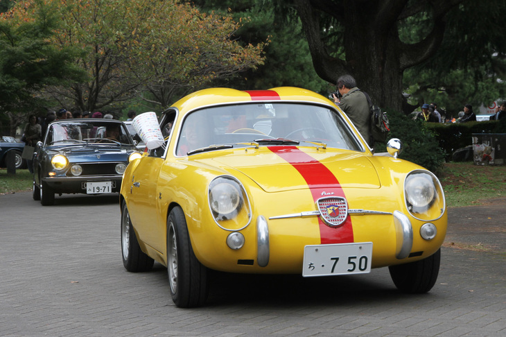 閉会式終了後、地元新聞社から配られた小旗を振るギャラリーに見送られ、エントリー車両はパレード形式で退場する。1957年「フィアット・アバルト750GTザガート」に1971年「シムカ1200Sクーペ」が続く。