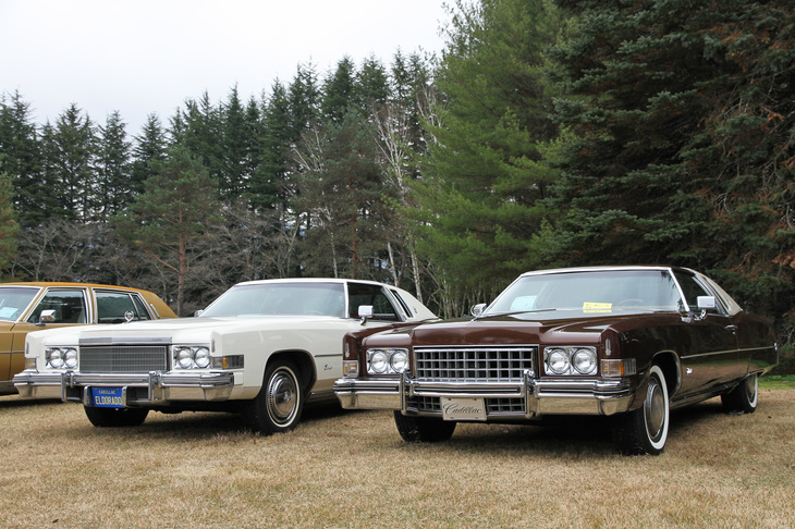右は1973年、左は1974年の「キャデラック・エルドラド」。全長5.6m超、全幅2m超の2ドアハードトップボディーに搭載した、8.2リッターという乗用車史上最大のV8エンジンで前輪を駆動する、史上最大のFF車。