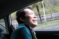 “ぶしつけ顔”で後席窓の開口部を測る筆者。