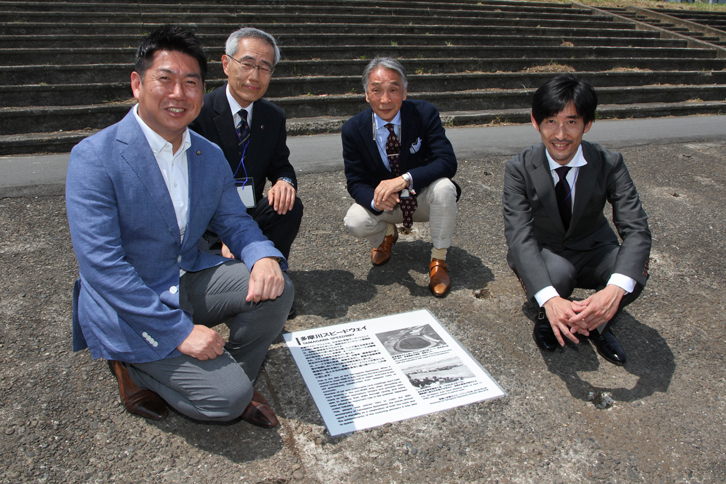 除幕を行った4名。右端から多摩川スピードウエイの会 副会長 小林大樹氏、ヴェテランカークラブ東京 会長 堺 正章氏、日本クラシックカークラブ 役員 山本英継氏、川崎市長 福田紀彦氏。福田氏いわく「小林さんから伺うまでは、恥ずかしながら多摩川スピードウエイのことはまったく知らなかった。グランドスタンド跡を通るたびに、ここはいったい何だったのだろう？ と思っていた」とのこと。今では「川崎市としても、この活動を盛り上げていきたい」という。