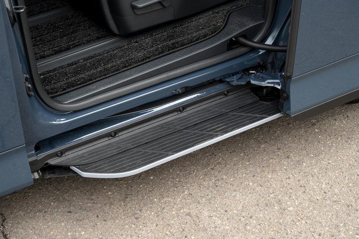 スライドドアの動きと連動して展開する「ユニバーサルステップ」。電動アクチュエーターではなく“カラクリ”でもって作動する機構とし、手ごろな価格設定を実現した。（写真：向後一宏）