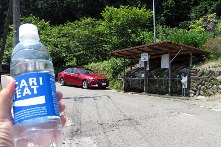 帰りは急峻（きゅうしゅん）な風布地区の峠道を越え、日本の名水百選に数えられる日本水の水くみ場に立ち寄った。大変おいしゅうございます。