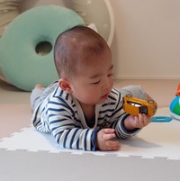 「ルノー・トゥインゴ」のミニカーをじっくり観察するわが子。生後9カ月でこんなマニアックなクルマに興味を示すなんて、天才かもしれない（親バカ）。