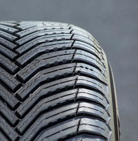 「クロスクライメート2」は性能の持続性もセリングポイントのひとつ。摩耗が進むに従ってブロック側面に新たな凹凸と溝が現れ、排水・排雪性をキープする仕組みになっている。写真でショルダー部に見られる3つのドット（点）は、摩耗度を示す独自のセンサーである「トレッドウェアサイン」。道路運送車両法に基づくスリップサインは別途用意される。