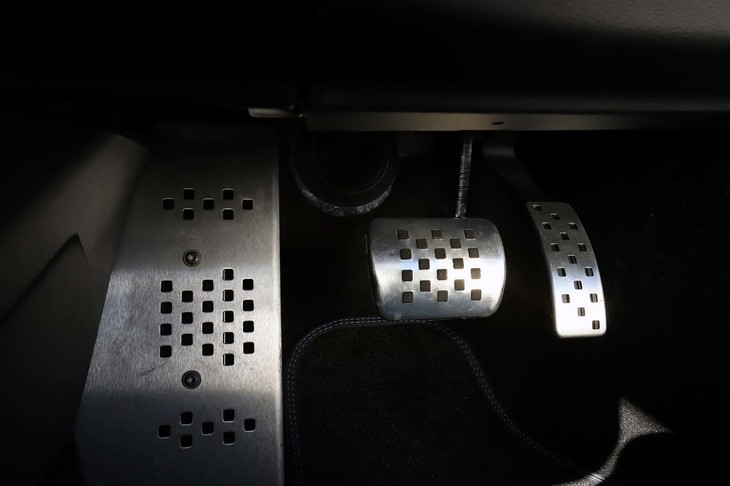 ドライバーの足元には、アルミ製のペダルやフットレストが並ぶ。