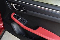 ドアパネルにもレッドのレザーがあしらわれている。たっぷりとしたサイズのドアポケットには大きめのボトルを入れることもできる。