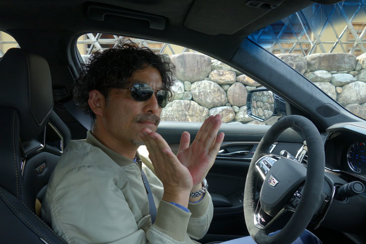 “V”モデルの強力な動力性能を堪能し、ご満悦の筆者。思わず両手でVを描いた。（写真＝webCG）