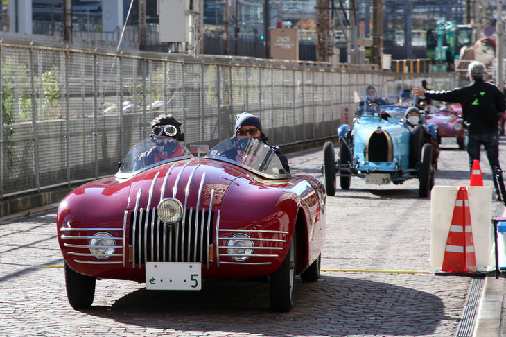 スタート直後、イタリア街の裏手にある、JRの線路と並行した道で“線踏み”（計測センサーが仕込まれた線をタイヤで踏むことから、PC競技のことを俗にそう呼ぶ）を実施。先頭は1939年「フィアット508Cアラドーロ」。戦前から1960年代までフィアットの主力車種だった「1100」のコンポーネンツを流用したスペシャルモデル。