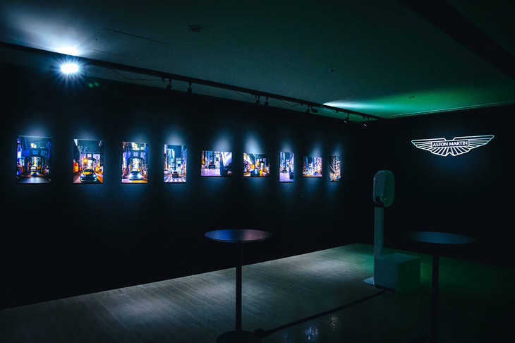 会場を飾る、東京の街なかを行く「アストンマーティンDBX707ミッドナイト ポディウムエディション」の写真。