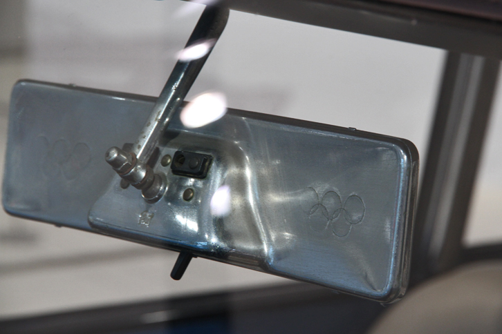 「クーペ」のインナーミラー。左右に五輪マークが筋彫りされているのがおわかりだろうか。この年（1960年）に開かれたローマオリンピックを祝したものと思われる。ちなみにコンバーチブルには、形状が異なるものが装着されており、そちらには五輪マークもない。