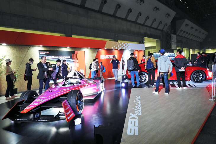 ポルシェは東京大会専用にピンクのカラーリングを施したレーシングカー「99Xエレクトリック」と、電気自動車の「タイカン」を展示。派手な展示に、皆が足を止めていた。