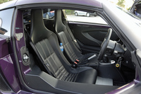 ドア開口部を55mm広げたおかげで乗降性は確かに改善されている。このショットからもサイドフレームを抉るように低くしたことがはっきりとわかる。ルーフはエキシージと同じくただのフィクストヘッドではない構造体であり、オープンモデルを作る可能性は少ないはず。シートの間にはペットボトル1本分の小物入れが備わる。
