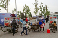 プレスデイ前日、最寄りの国展駅の前には、中国風クレープ「ジェンビン」の三輪車屋台が並ぶ。