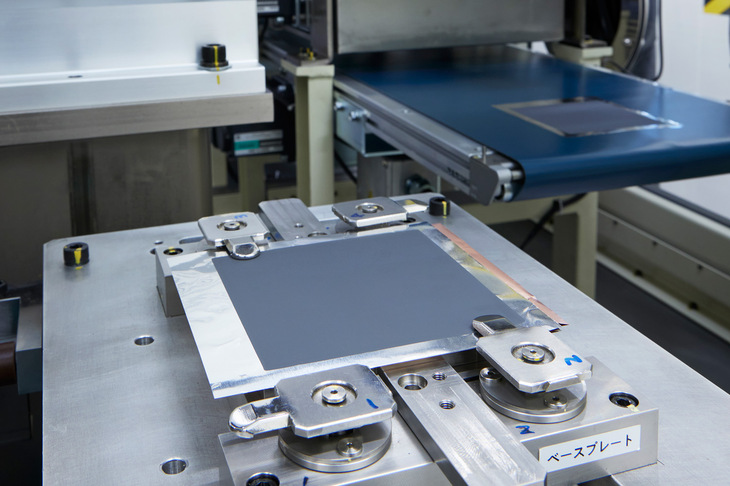 裁断した正極に負極を積層。負極の表面には、リチウムの析出を均一にするため、伝導体の中間層がコーティングされている。あとはラミネートフィルムで挟んでセルが完成。複数のセルを重ねてタブを溶接し、積層ラミネートセルが完成する。