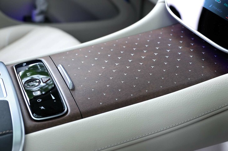 試乗車のインテリアに採用されていた、新設定の「ブラウンマグノリアウッドトリム」。精緻なスリーポインテッドスターの模様は、オープンポアアッシュウッドにレーザー加工で穴をあけ、ステンレススチールの薄板を裏からプレスして押し込む……という、特殊な象嵌（ぞうがん）技法によって実現したものだ。