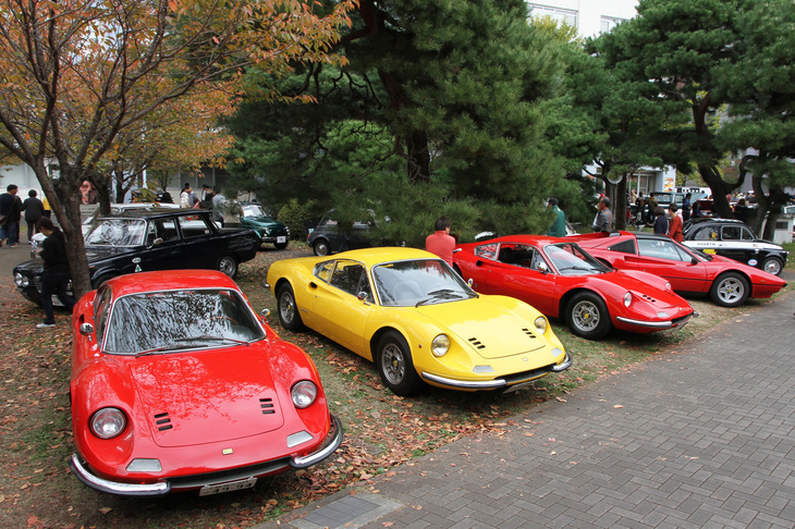 左から1968年「ディーノ206GT」、1970年＆74年「ディーノ246GT」、そして1980年「フェラーリ308GTS」。後方には「アルファ・ロメオ・ジュリア ベルリーナ」や「フィアット500」が並ぶ。