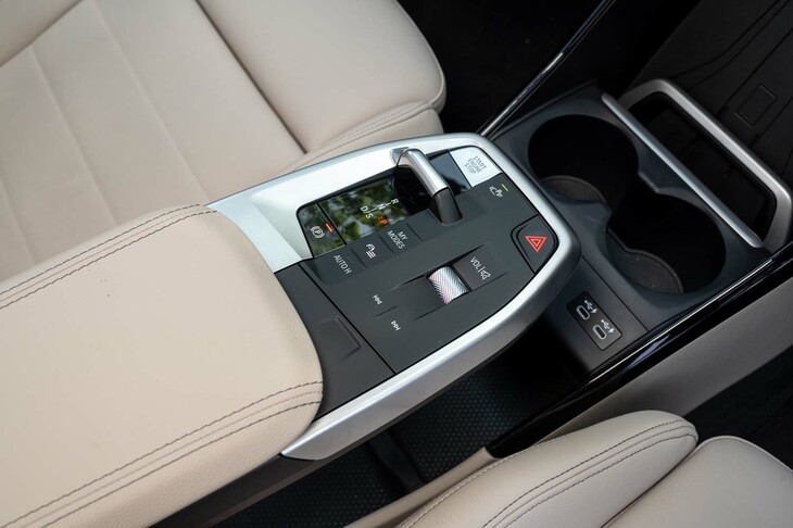 高さを抑えたシフトセレクターをはじめ、センターコンソールのスイッチ類はフラットにレイアウトされる。アームレストの下には浅い収納スペースがあるものの、ヒンジがドライバー側にあるため左からしか開かない。