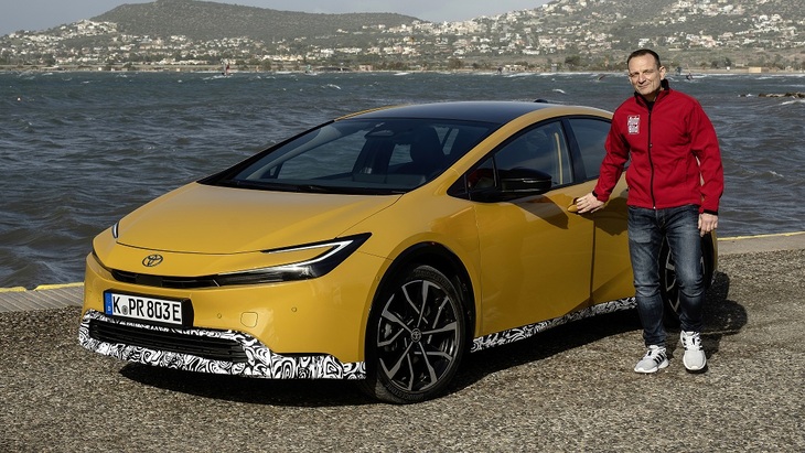 新型「トヨタ・プリウス」と筆者。量産ハイブリッド車の代名詞的存在であるプリウスは、フルモデルチェンジでハンサムなスポーツカーへと生まれ変わった。