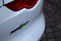 「R」グレードの4WD車であることを示すリアバンパーのバッジ。4WD化により、車両重量はFR車より50kg重くなった。