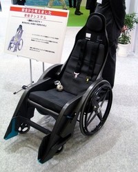 フレームはカーボン！　4点式シートベルトを備える、童夢製の車いすシステム。