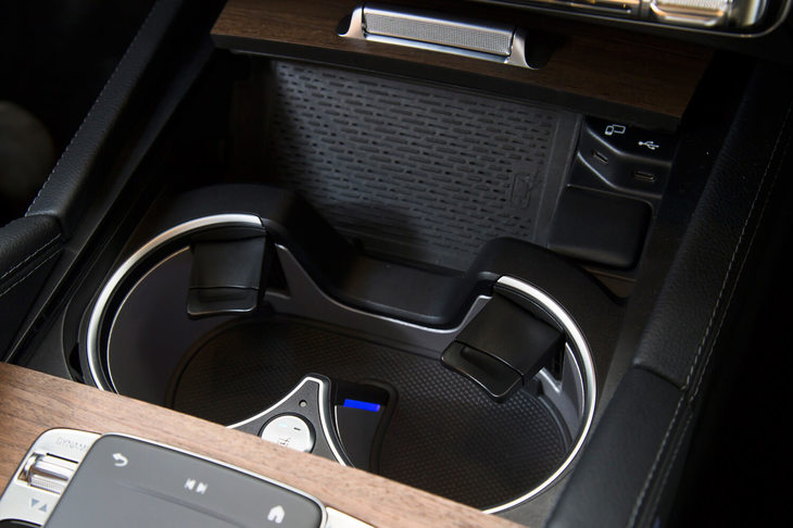 前席用カップホルダーは温冷機能付き。その前方にある小物入れスペースでは、Qi（チー）規格のスマートフォンを置くだけで充電できる。