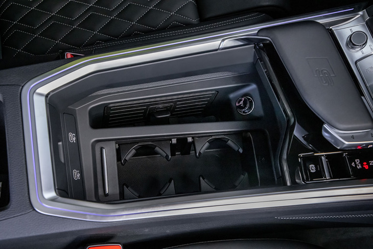 「S」ロゴ付きパームレストのサイドにプッシュスライド式のシフトセレクターが配置されるアウディ独自のデザインは、マイナーチェンジモデルでも継続。「SQ8スポーツバックe-tron」にはカップホルダーの横にスロット形状のワイヤレスチャージングを標準で装備している。