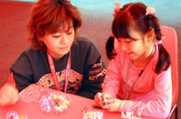 講習中、お子様方は塗り絵やビーズを楽しんだ。スタッフもいるからお父さん、お母さんも安心。普通のドライビングスクールでは見られない一場面だ。