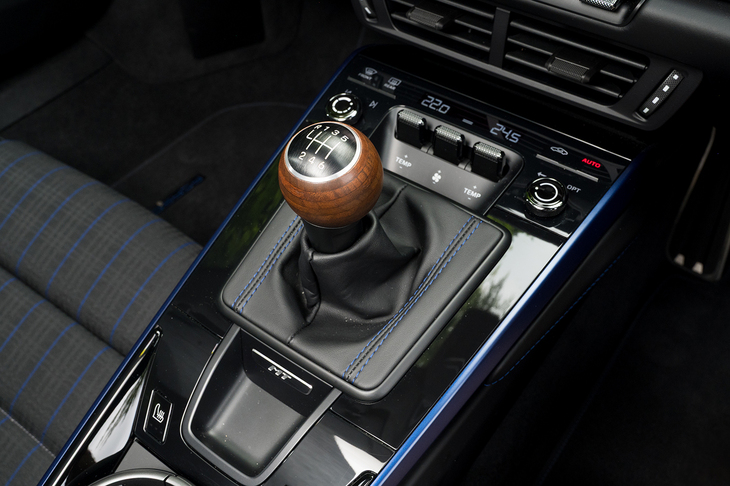 6段MTのシフトレバーは積層ウォールナット材のオープンポア仕上げ。後方にはわざわざ「MT」の小さなバッジが貼ってある。