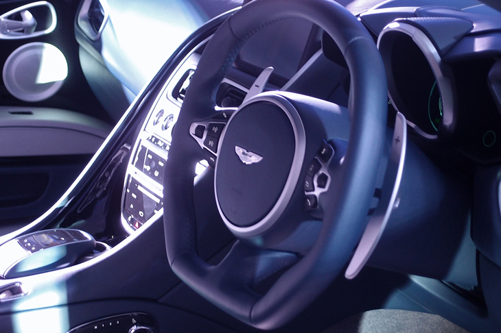 スクエアな形状のステアリングホイール。スポーク部にはサスペンションの調節スイッチが備わる。