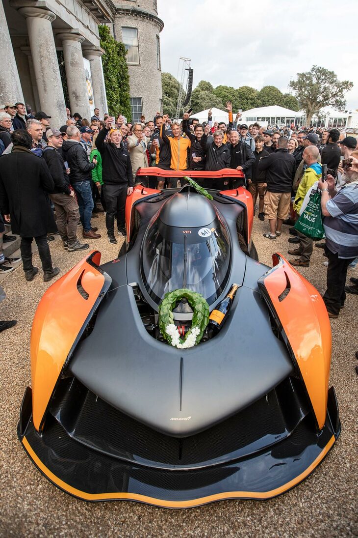 「マクラーレン・ソラスGT」を囲む来場者と、酒杯をあげるマクラーレンの関係者。よく見ると、グラスを持つ人のなかには、リッチモンド公爵の姿も。