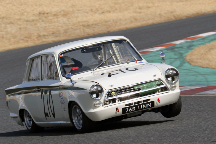 スーパークリスタル／ハイパークリスタル決勝で、コースイン直前にエンジンがかからなくなってしまった「ロータス・コーティナMk1 Sr1」。他車がフォーメーションラップ中になんとか復活してピットレーンからスタート、コーナーでは内側前輪をリフトさせながら追い上げた。