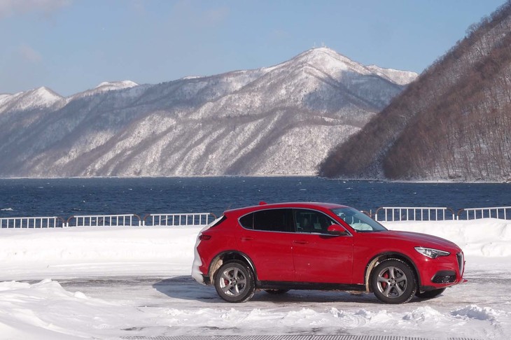 北海道・千歳市の支笏湖畔にて。「ステルヴィオ」のサイドビューは「止まっていても、いまにも走りだしそうな躍動感」が表現されている。