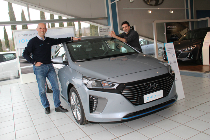 グレーの「アイオニック ハイブリッド」を前に、「IONIQ」のロゴ入りセーターで気合が入る営業のチェーザレさん（写真左）。隣に立つのは、同僚のジョヴァンニさん。