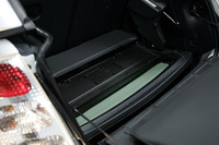 カブリオレにするには、トップとリアウィンドウを一体化させたあとリアハッチゲートを開き、リアウィンドウにあるスイッチで写真のように上へ持ち上げる。その後、荷室床下を開き、全体を収納（写真をクリックすると見られます）する。