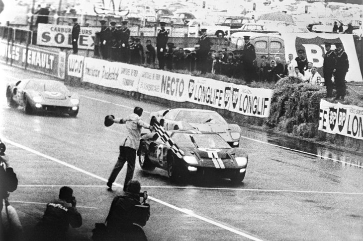 24時間を走り切り、チェッカーを受ける「フォードGT40」。1966年のルマンで、フォードは1～3位を独占した。
