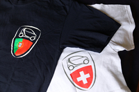 上下の写真は、メーカー主催の「スマート」の国際ファン大会「スマートタイムズ」における記念品。写真左の紺色のTシャツは2014年のポルトガル（カスカイス）大会、右は2013年のスイス（ルツェルン）大会のもの。