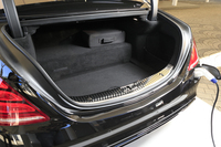 容量365リッターのトランクルーム。奥の段差部分にリチウムイオンバッテリーがおさまる。その上に見られるのは、充電ケーブルをおさめる専用バッグ。充電プラグは、写真のようにリアバンパー右側に挿入する。