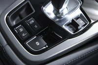 シフトレバーの傍らには、走行モードの選択スイッチが置かれる（写真右側）。左手に見えるのはエキゾーストノートを変化させる「アクティブエグゾーストシステム」のスイッチ。「Fタイプ クーペ」では、この機能は37万円のオプションとなる。