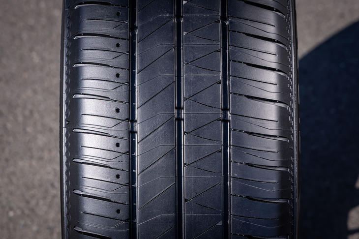 ブリヂストンが「スクエアグルーヴ」と呼ぶ3本の主溝を中心にデザインされたトレッドパターン。タイヤのアウト側ブロックには接地端に向けて溝幅を広くし排水性を向上させる「スプラッシュラグ」が組み込まれている。